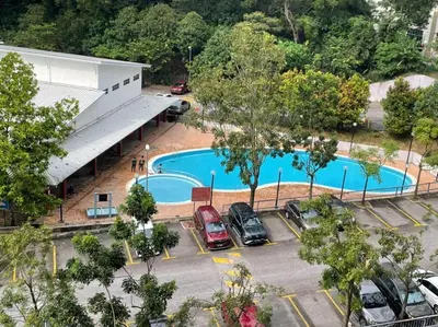 an overhead view of a parking lot with a pool at Indah Putri Homestay in Kuala Lumpur
