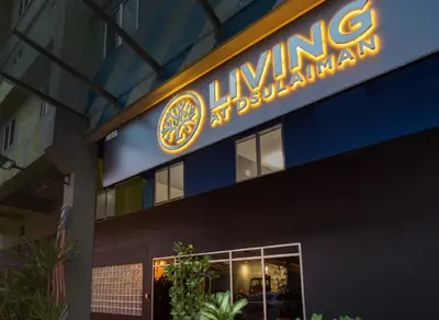 a lit up sign on the side of a building at Living At DSulaiman Hotel in Kuala Lumpur
