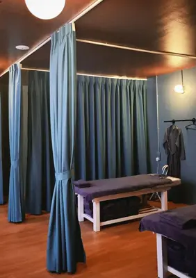 a room with blue curtains and a bed and a table at Bintang Collectionz Hotel in Kuala Lumpur