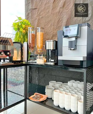 a counter with a coffee maker and cups on it at Bintang Collectionz Hotel in Kuala Lumpur