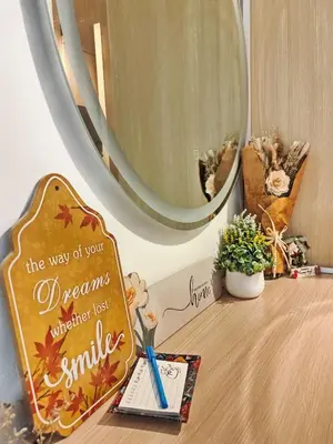 a table with a mirror and a sign on it at CL24B 2-3pax KLCC Apartment in Kuala Lumpur