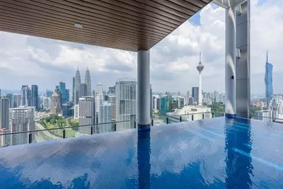 a swimming pool on top of a building with a city skyline at CL24B 2-3pax KLCC Apartment in Kuala Lumpur