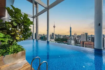 a swimming pool on top of a building with a city skyline at CL24B 2-3pax KLCC Apartment in Kuala Lumpur