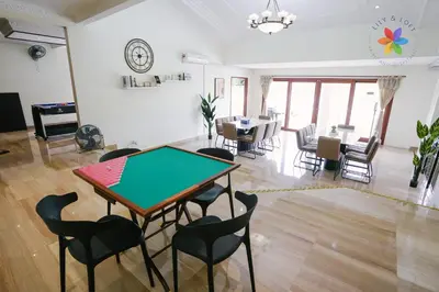 a living room with a ping pong table and chairs at 40P, Bangsar Villa with Pool/Karaoke/Gathering/BBQ in Kuala Lumpur