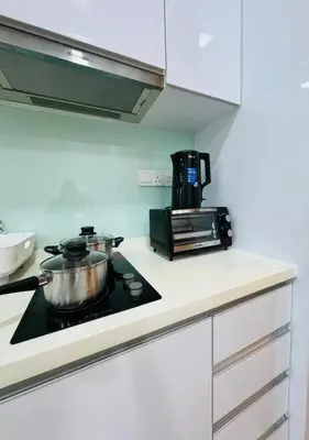 a kitchen with a stove with two pots on it at Bintang Suites Kuala Lumpur City Centre in Kuala Lumpur