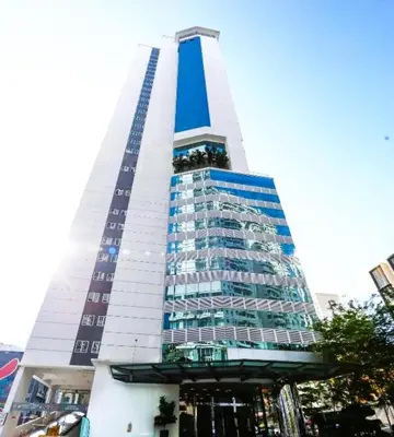 a tall building with a blue and white at Bintang Suites Kuala Lumpur City Centre in Kuala Lumpur