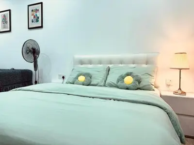 a bedroom with a bed with two stuffed animals on it at Bintang Suites Kuala Lumpur City Centre in Kuala Lumpur
