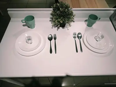 a white table with two plates and silverware on it at Arte Plus by Stay Relax in Kuala Lumpur