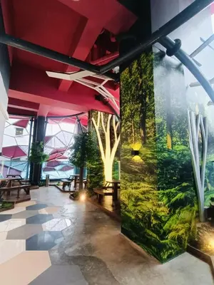 a lobby with a large mural of trees at Arte Plus by Stay Relax in Kuala Lumpur