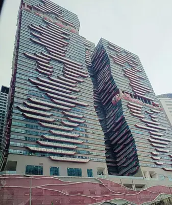 a tall building with many windows on the side of it at Arte Plus by Stay Relax in Kuala Lumpur