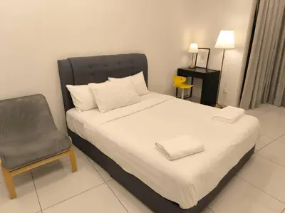 a bedroom with a bed and a chair in it at 043 Sweet Home Robertson in Kuala Lumpur