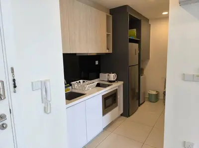 a kitchen with white cabinets and a sink and a refrigerator at 043 Sweet Home Robertson in Kuala Lumpur