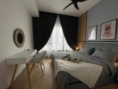 a bedroom with a bed and a desk and a ceiling fan at Luxury Suite Lucentia BBCC Infinity Pool in Kuala Lumpur