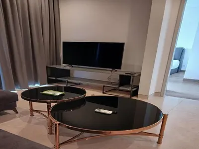 a living room with a table and a tv at Luxury Suite Lucentia BBCC Infinity Pool in Kuala Lumpur