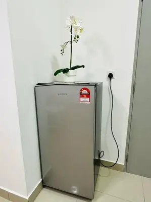 a plant sitting on top of a refrigerator at M Vertica KL City 3B2B 8 Pax [Wi-Fi, 2 Carparks] in Kuala Lumpur