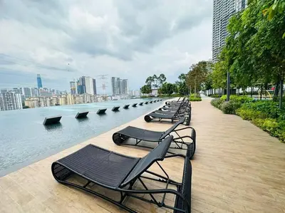 a row of benches sitting next to a body of water at M Vertica KL City 3B2B 8 Pax [Wi-Fi, 2 Carparks] in Kuala Lumpur