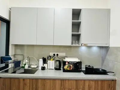 a kitchen with white cabinets and a counter top at M Vertica KL City 3B2B 8 Pax [Wi-Fi, 2 Carparks] in Kuala Lumpur