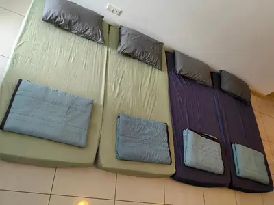a group of pillows on a bed in a room at 9 Bukit Bintang 5 minutes to Alor Street Seri Bukit Ceylon 2R2B 8 pax in Kuala Lumpur