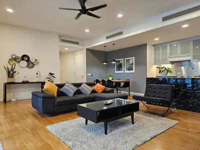 a living room with a couch and a table at Cosy Apartment at St Mary KL City Centre in Kuala Lumpur