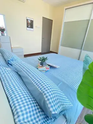 a blue bed with blue pillows and a plant on it at CozyVista Setapak Central Mall 10Pax 3BR 2CarPark in Kuala Lumpur
