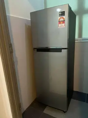a stainless steel refrigerator in a kitchen next to a wall at CozyVista Setapak Central Mall 10Pax 3BR 2CarPark in Kuala Lumpur