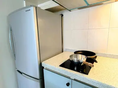a kitchen with a white refrigerator and a pot on a stove at VintageHome Lalaport Casa Mutiara Bukit Bintang by Scape Stay in Kuala Lumpur