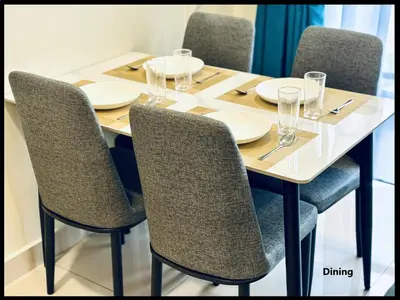 a table with chairs and plates and glasses on it at Skystays360 KL, 60th floor - close to KLCC TRX 2-bedroom 2 bathrooms in Kuala Lumpur