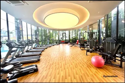 a gym with a bunch of treadmills and machines at Skystays360 KL, 60th floor - close to KLCC TRX 2-bedroom 2 bathrooms in Kuala Lumpur