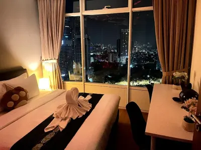 a hotel room with a bed and a window with a view at Vortex Suites KLCC 10 Pax -3 Bedroom Apartment in Kuala Lumpur