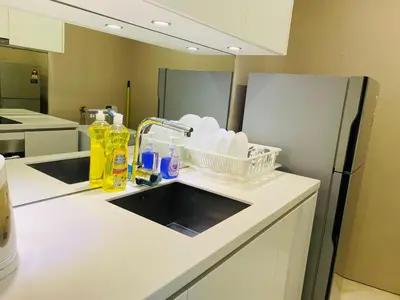 a kitchen counter with a sink and a refrigerator at Vortex Suites KLCC 10 Pax -3 Bedroom Apartment in Kuala Lumpur