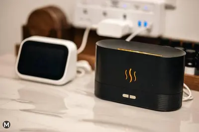 a black device sitting on a table next to acomputervisor at 10 Mins to KL City - Modern Suite 6 Pax M Vertica in Kuala Lumpur