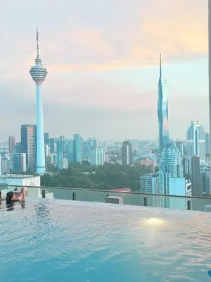 a infinity pool with a view of the city at Luxe Suites Home KLCC in Kuala Lumpur