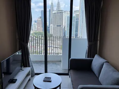 a living room with a couch and a large window at Luxe Suites Home KLCC in Kuala Lumpur