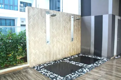 a shower with a sign on the side of a building at Luxe Suites Home KLCC in Kuala Lumpur