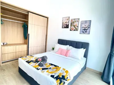 a small bedroom with a bed with white sheets at Luxe Suites Home KLCC in Kuala Lumpur