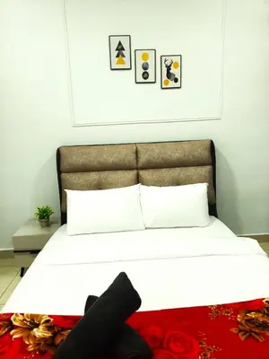 a bedroom with a white bed with a red rug at Luxe Suites Home KLCC in Kuala Lumpur