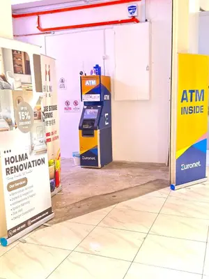 an atm machine in a room with signs at The Luxe Suites Infinitum KLCC in Kuala Lumpur