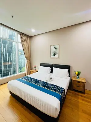 a hotel room with a bed and a large window at Soho Star Suites near by Klcc in Kuala Lumpur