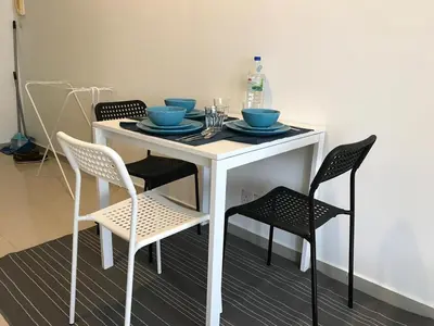 a white table with chairs and blue bowls on it at Parkview MALIKA KLCC in Kuala Lumpur
