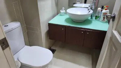 a bathroom with a white toilet and a sink at Parkview MALIKA KLCC in Kuala Lumpur
