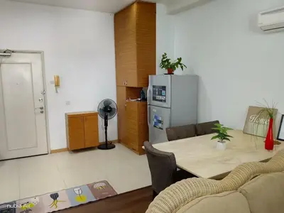 a living room with a table and a refrigerator at Parkview MALIKA KLCC in Kuala Lumpur