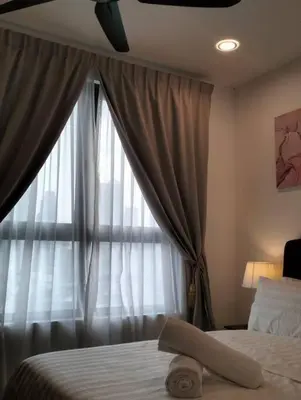 a bedroom with a bed and a window with curtains at MH Homestay 3R2B Condo very near to KLCC, Free Wi-Fi, Netflix & Parking in Kuala Lumpur