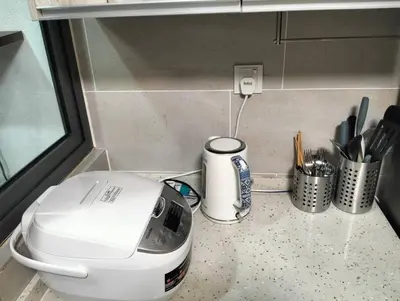 a toaster sitting on a counter with pens and utensils at MH Homestay 3R2B Condo very near to KLCC, Free Wi-Fi, Netflix & Parking in Kuala Lumpur
