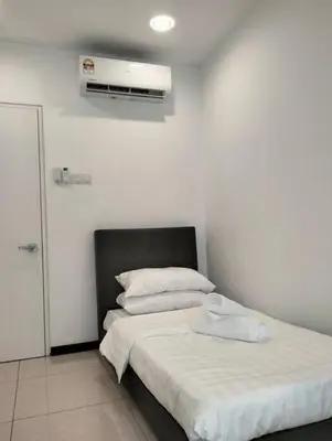 a bedroom with a bed and a air conditioner on the wall at MH Homestay 3R2B Condo very near to KLCC, Free Wi-Fi, Netflix & Parking in Kuala Lumpur