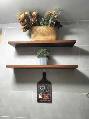 a shelf with two plants and a picture on it at MH Homestay 3R2B Condo very near to KLCC, Free Wi-Fi, Netflix & Parking in Kuala Lumpur