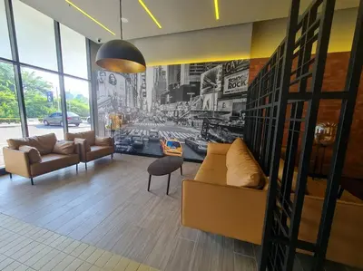 a living room with couches and a wall with posters at Tiny Studio Suite Near Gleneagles 10 mins to KLCC in Kuala Lumpur