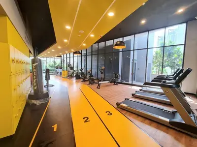 a gym with rows of treadmills in a room at Tiny Studio Suite Near Gleneagles 10 mins to KLCC in Kuala Lumpur