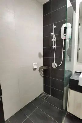 a shower with a glass door in a bathroom at Modern Comfy Studio Permaisuri 2 Carpark WIFI in Kuala Lumpur