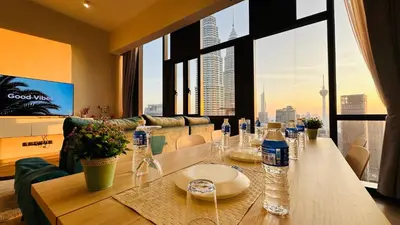 a table in a living room with a view of a city at Star Residence Suite KLCC in Kuala Lumpur