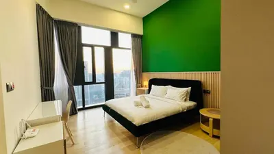 a green room with a bed and a green wall at Star Residence Suite KLCC in Kuala Lumpur